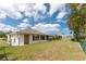 Large backyard featuring a well-maintained lawn and partial fencing for added privacy at 25046 Doredo Dr, Punta Gorda, FL 33955