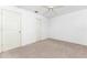 An empty bedroom with a ceiling fan, carpet, and standard closet doors at 25046 Doredo Dr, Punta Gorda, FL 33955