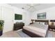 A primary bedroom with a neutral color palette, stylish furnishings, and tv at 25046 Doredo Dr, Punta Gorda, FL 33955