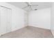 Bedroom featuring neutral carpeting, a ceiling fan, and closet for storage at 25046 Doredo Dr, Punta Gorda, FL 33955