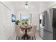 Cozy breakfast nook with furniture, enhanced by a stainless steel refrigerator and serene outdoor view at 25046 Doredo Dr, Punta Gorda, FL 33955