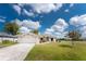 Charming single-story home with a well-manicured lawn and attached two-car garage at 25046 Doredo Dr, Punta Gorda, FL 33955
