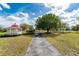 A charming gazebo sits near a pathway, inviting relaxation amid lush greenery and blue skies at 25046 Doredo Dr, Punta Gorda, FL 33955