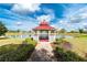 Picturesque gazebo overlooking a serene pond, adding a touch of tranquility to the community at 25046 Doredo Dr, Punta Gorda, FL 33955