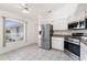 Bright kitchen with a stainless steel refrigerator and an adjacent dining area with natural light at 25046 Doredo Dr, Punta Gorda, FL 33955