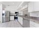Well-lit kitchen featuring stainless steel appliances, including a refrigerator, microwave, and range at 25046 Doredo Dr, Punta Gorda, FL 33955