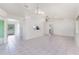 Spacious living room with tile flooring, skylight, and modern chandelier at 25046 Doredo Dr, Punta Gorda, FL 33955