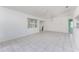 Open floorplan living room featuring tile flooring, a ceiling fan, and views of the backyard at 25046 Doredo Dr, Punta Gorda, FL 33955