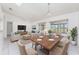 Bright living room showcasing a dining area, seating, tiled floors, and backyard views at 25046 Doredo Dr, Punta Gorda, FL 33955