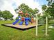 Colorful playground equipment for children ages 2-12 set in a green, open community space at 25046 Doredo Dr, Punta Gorda, FL 33955