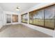 Enclosed sunroom featuring tiled floors, a ceiling fan, and large windows with backyard views at 25046 Doredo Dr, Punta Gorda, FL 33955