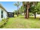 This lush backyard features a screened patio, mature trees, and a well-maintained lawn at 25324 Aysen Dr, Punta Gorda, FL 33983