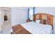 Comfortable bedroom with a wooden headboard, closet, and view into the hall at 25324 Aysen Dr, Punta Gorda, FL 33983
