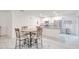 Bright open kitchen with stainless appliances, an island, and an adjacent dining area with a table at 25324 Aysen Dr, Punta Gorda, FL 33983