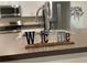 Close-up of modern kitchen sink with stainless steel appliances in background at 25324 Aysen Dr, Punta Gorda, FL 33983