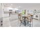 Bright open kitchen with stainless appliances, an island, and an adjacent dining area with a table at 25324 Aysen Dr, Punta Gorda, FL 33983