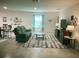 Spacious living room with neutral decor, large window, and tile flooring at 25324 Aysen Dr, Punta Gorda, FL 33983