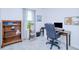 Home office features desk, chair, bookcase, and bright window at 25324 Aysen Dr, Punta Gorda, FL 33983