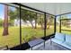 The screened patio features comfortable seating with views of the lush backyard at 25324 Aysen Dr, Punta Gorda, FL 33983