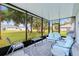 The screened patio features comfortable seating with beautiful views of the lush backyard at 25324 Aysen Dr, Punta Gorda, FL 33983