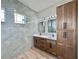 Bathroom with double sinks, granite countertop, tile accents, and spacious cabinets at 2743 Begonia Ter, North Port, FL 34286