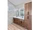 Bathroom with double sinks, granite countertop, tile accents, and spacious cabinets at 2743 Begonia Ter, North Port, FL 34286