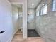 Bathroom featuring a walk-in shower with tile and a separate toilet room at 2743 Begonia Ter, North Port, FL 34286