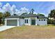 This home has a 2 car garage and a manicured lawn at 2743 Begonia Ter, North Port, FL 34286