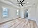Main bedroom with tray ceiling, large windows, and ensuite bathroom entrance at 2743 Begonia Ter, North Port, FL 34286