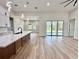 The open floor plan has a dining area, kitchen, and sliding glass doors to the outside at 2743 Begonia Ter, North Port, FL 34286