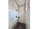 Walk-in shower featuring decorative tile walls, rainfall showerhead, and built-in shelf at 2743 Begonia Ter, North Port, FL 34286