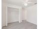 Bedroom features wood look floors, closet, ensuite bathroom, and a ceiling fan at 27438 Corinthian Dr, Punta Gorda, FL 33955