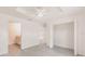 Bright bedroom features wood look floors, ensuite bath, closet, and ceiling fan at 27438 Corinthian Dr, Punta Gorda, FL 33955