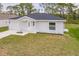 Charming single-story home featuring a well-manicured lawn and a cozy, covered entryway at 27438 Corinthian Dr, Punta Gorda, FL 33955
