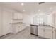 Open-concept kitchen with stainless steel appliances, wood floors, and an eat-in countertop at 27438 Corinthian Dr, Punta Gorda, FL 33955