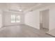 Bright living room with wood flooring, ceiling fan and large window offering lots of natural light at 27438 Corinthian Dr, Punta Gorda, FL 33955