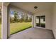 View from the covered patio overlooks a grassy lawn with a backdrop of trees at 27438 Corinthian Dr, Punta Gorda, FL 33955
