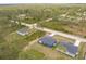 An aerial view of multiple single-Gathering homes surrounded by lush green trees in a neighborhood at 27444 Corinthian Dr, Punta Gorda, FL 33955