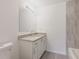 Modern bathroom featuring a granite vanity countertop, sleek faucet, and a decorative mirror with vanity lighting at 27444 Corinthian Dr, Punta Gorda, FL 33955
