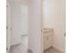 Tastefully designed powder room with a sleek vanity featuring a granite countertop and modern fixtures at 27444 Corinthian Dr, Punta Gorda, FL 33955