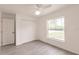 Bright bedroom with light wood-look flooring, double closet, and large window with natural light and outdoor view at 27444 Corinthian Dr, Punta Gorda, FL 33955