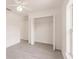Bright bedroom featuring light-colored flooring, a window, and an open closet with shelving for storage at 27444 Corinthian Dr, Punta Gorda, FL 33955