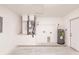 Bright garage featuring modern mechanical systems and a utility sink with space for parking or storage at 27444 Corinthian Dr, Punta Gorda, FL 33955
