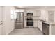 Modern kitchen with stainless steel appliances and white cabinets at 27444 Corinthian Dr, Punta Gorda, FL 33955