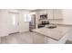 Modern kitchen with stainless steel appliances and white cabinets at 27444 Corinthian Dr, Punta Gorda, FL 33955