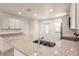 Modern kitchen island features stainless steel appliances and granite countertops at 27444 Corinthian Dr, Punta Gorda, FL 33955