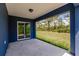 Covered patio with sliding glass doors offers seamless indoor-outdoor living and views of the spacious backyard at 27444 Corinthian Dr, Punta Gorda, FL 33955