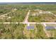 Aerial view of the home nestled among lush trees and landscaping at 27456 Corinthian Dr, Punta Gorda, FL 33955