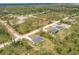 Aerial view of the neighborhood with trees and the new home at 27456 Corinthian Dr, Punta Gorda, FL 33955