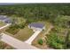 Overhead view of the new home with landscaping, driveway, and a spacious yard at 27456 Corinthian Dr, Punta Gorda, FL 33955